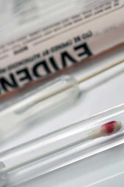 a swab of blood in a lab test tube as part of crime scene evidence
