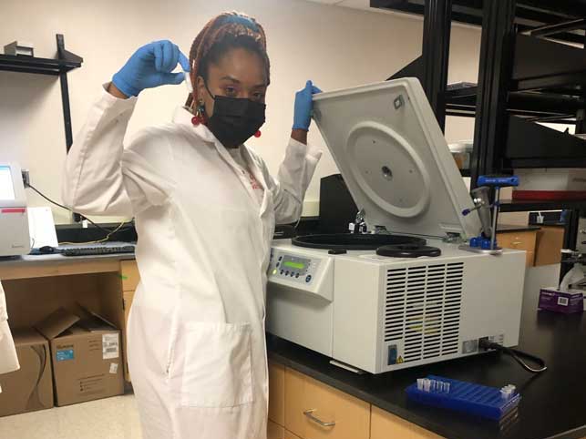 Amber Mundy using a piece of lab equipment in a forensic science laboratory